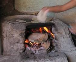 Clay cylinder with hearth inside and flat metal on top